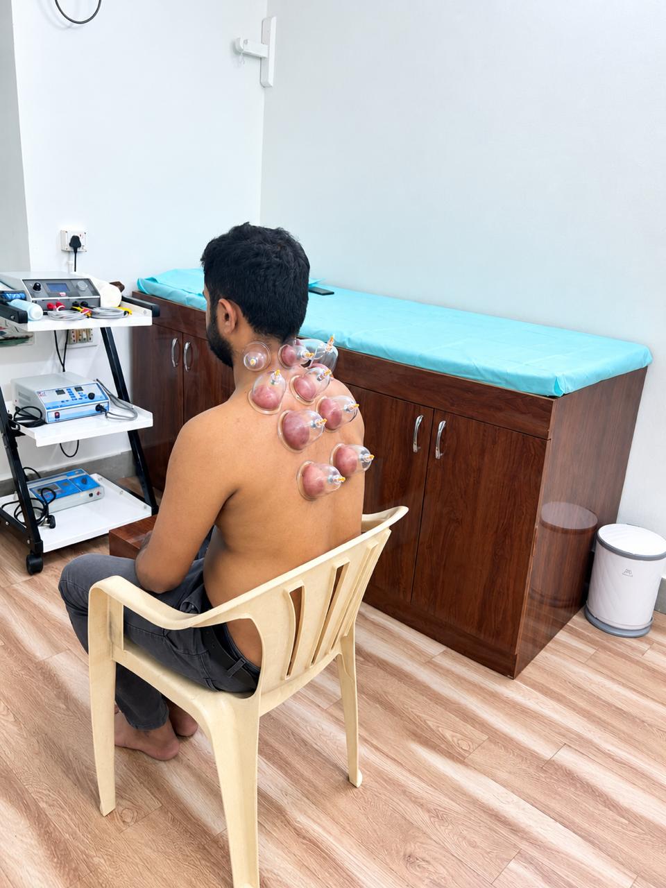 Patient receiving cupping therapy on the upper back and neck